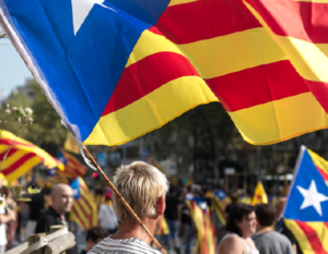 A man carrying a Catalan independence flag at a rally
