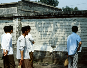 People look for names of dead & injured on a wall following Tiananmen Square massacre in 1989